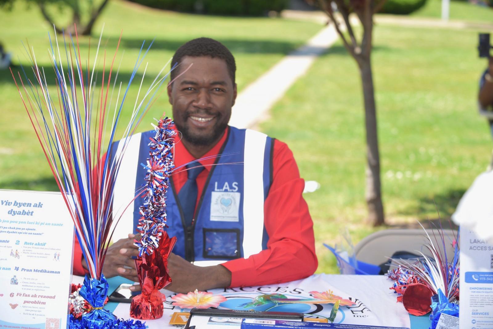 Dr. Lukenson Francois, President & CEO of Lakay Accès Santé, at the outreach table during Haitian Flag Day 2026