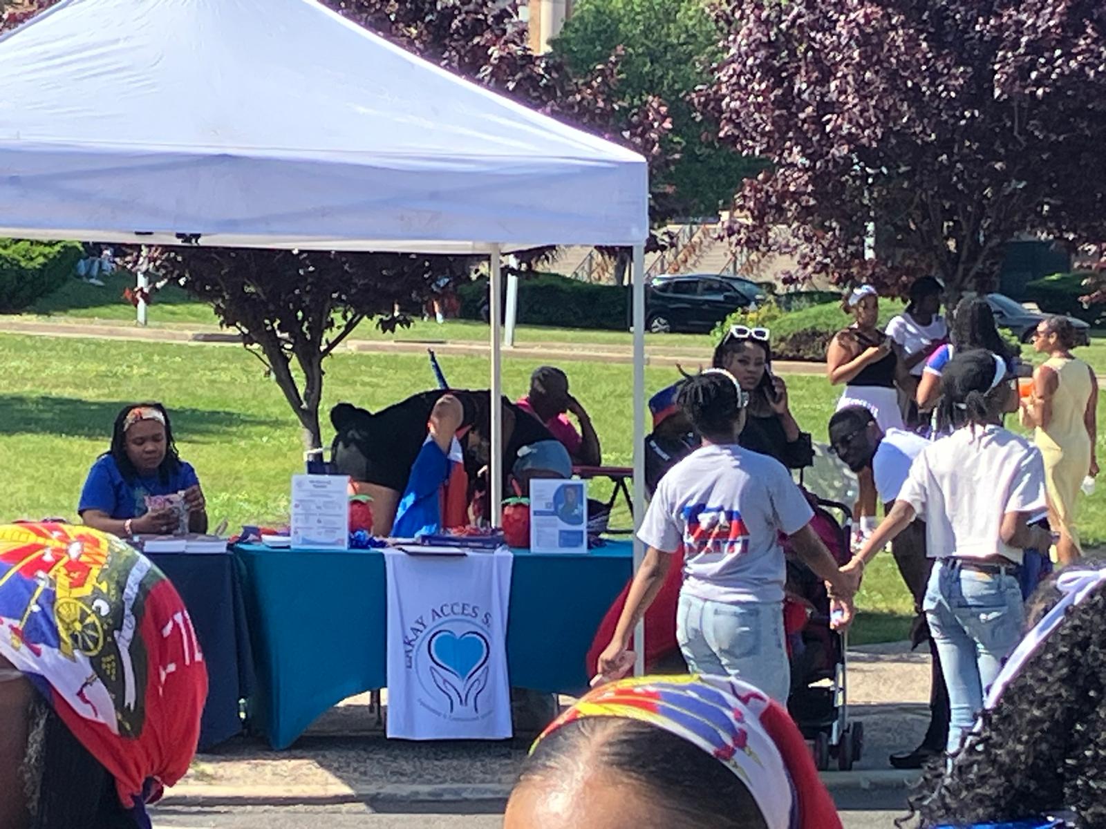 Lakay Accès Santé outreach table with volunteers at Haitian Flag Day 2026